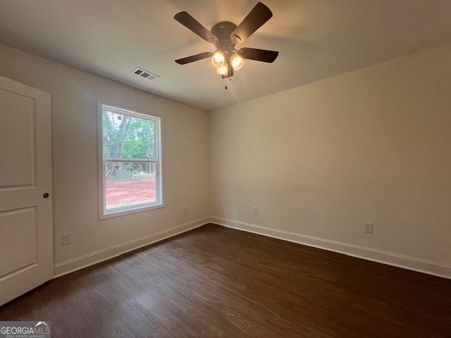 189 Warner Rd, Barnesville, GA 30204 - unfurnished room featuring dark wood-style floors, a ceiling fan, and baseboards
