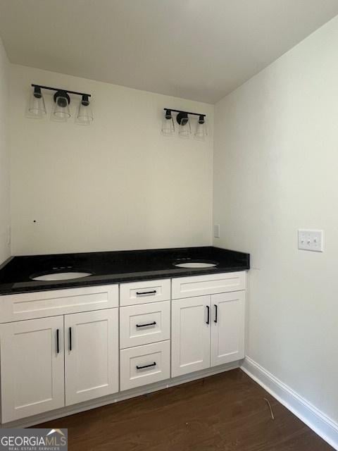 189 Warner Rd, Barnesville, GA 30204 - bathroom featuring wood finished floors, double vanity, and baseboards