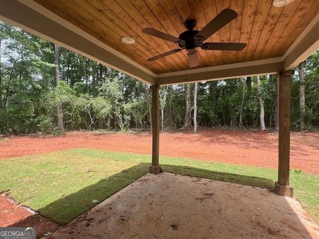 189 Warner Rd, Barnesville, GA 30204 - view of green lawn featuring a patio area, ceiling fan, and view of wooded area