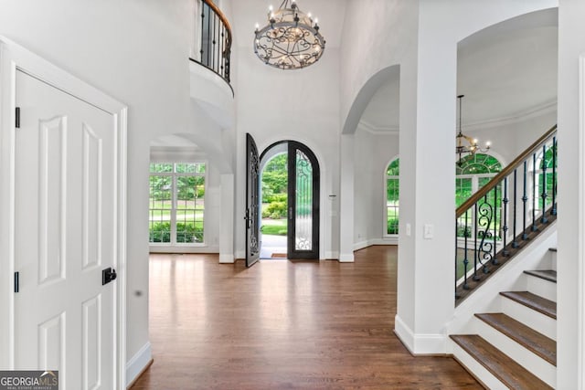 590 Arthur Rd, Canton, GA 30115 - entryway featuring a chandelier, arched walkways, dark wood-style flooring, a high ceiling, and stairs