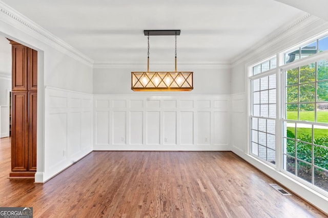 590 Arthur Rd, Canton, GA 30115 - unfurnished dining area with a decorative wall, wood finished floors, ornamental molding, and wainscoting