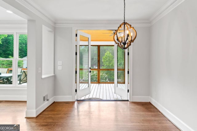 590 Arthur Rd, Canton, GA 30115 - doorway with a chandelier, wood finished floors, and ornamental molding
