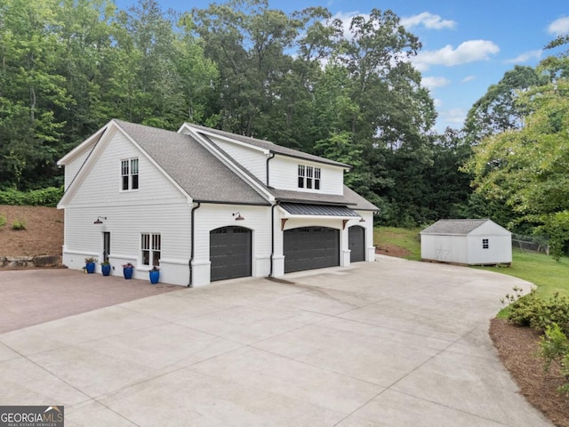 590 Arthur Rd, Canton, GA 30115 - view of side of property featuring driveway, a shingled roof, an attached garage, and a shed