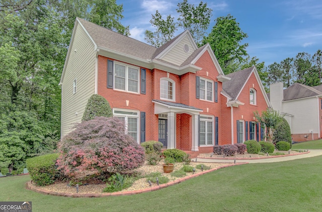 165 Hidden Lake Dr, Fayetteville, GA 30215 - view of front facade featuring a front lawn, brick siding, and roof with shingles