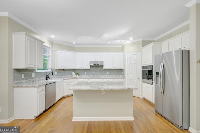 165 Hidden Lake Dr, Fayetteville, GA 30215 - kitchen featuring stainless steel appliances, a center island, white cabinets, and ornamental molding
