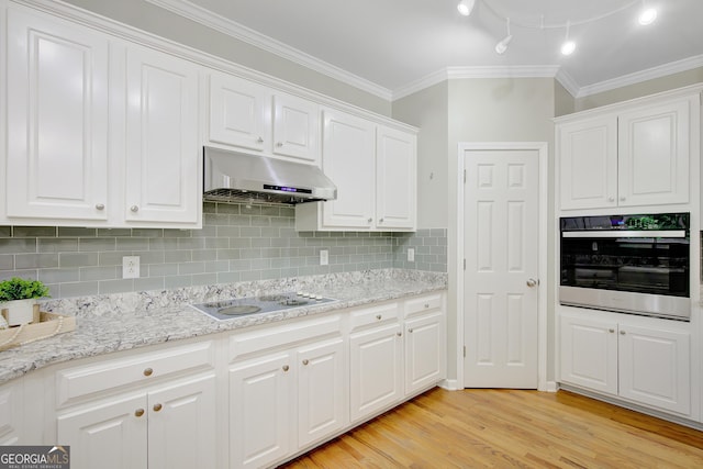 165 Hidden Lake Dr, Fayetteville, GA 30215 - kitchen with oven, under cabinet range hood, white electric stovetop, white cabinets, and ornamental molding