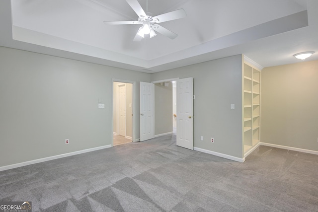 165 Hidden Lake Dr, Fayetteville, GA 30215 - unfurnished bedroom with carpet, a raised ceiling, baseboards, a spacious closet, and a ceiling fan