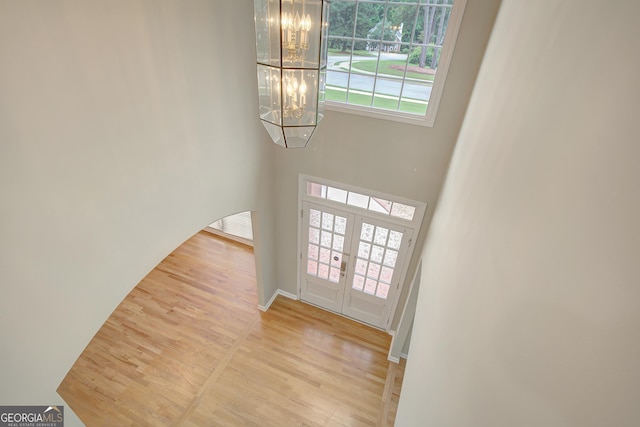 165 Hidden Lake Dr, Fayetteville, GA 30215 - foyer featuring a chandelier, wood finished floors, plenty of natural light, and french doors