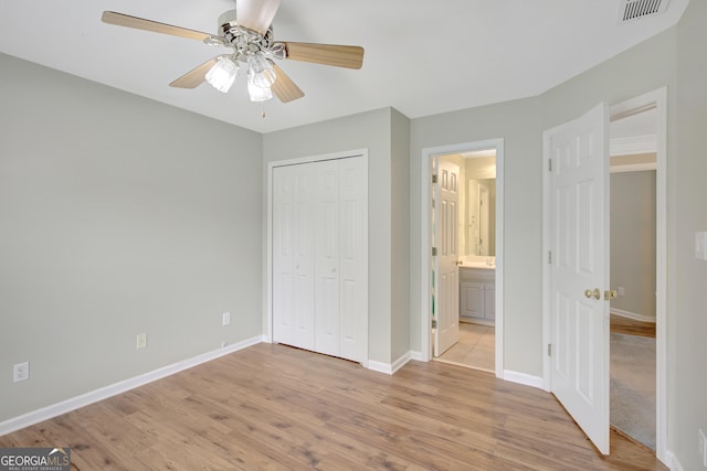 165 Hidden Lake Dr, Fayetteville, GA 30215 - unfurnished bedroom with light wood-type flooring, baseboards, and a closet