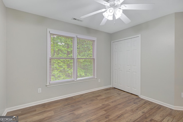 165 Hidden Lake Dr, Fayetteville, GA 30215 - unfurnished bedroom with wood finished floors, baseboards, a closet, and a ceiling fan