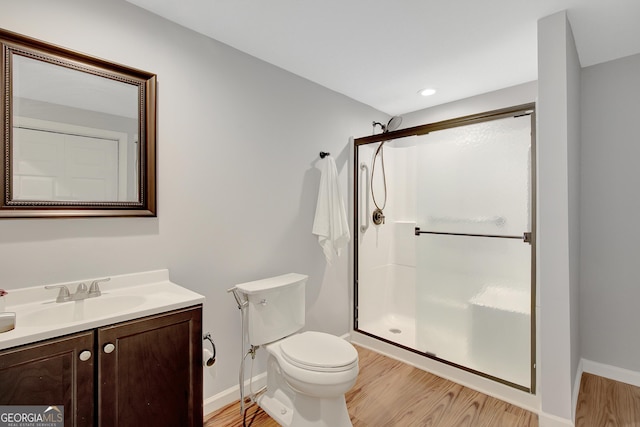 165 Hidden Lake Dr, Fayetteville, GA 30215 - bathroom with vanity, toilet, wood finished floors, a stall shower, and recessed lighting