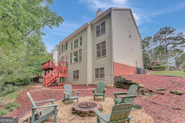 165 Hidden Lake Dr, Fayetteville, GA 30215 - back of property with a fire pit, stairway, a deck, cooling unit, and a chimney