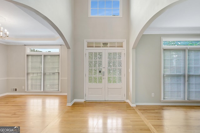 165 Hidden Lake Dr, Fayetteville, GA 30215 - foyer entrance featuring wood finished floors, ornamental molding, baseboards, a chandelier, and arched walkways