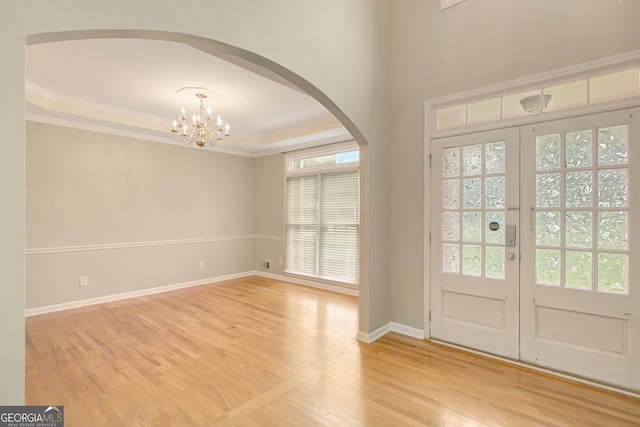 165 Hidden Lake Dr, Fayetteville, GA 30215 - entrance foyer with arched walkways, ornamental molding, light wood-style floors, a chandelier, and baseboards