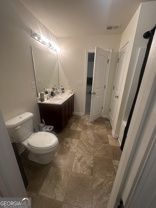 287 Ella Ct, Columbus, GA 31907 - bathroom with toilet, vanity, and stone finish flooring