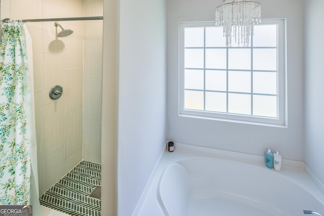 104 Johansen Way, Kingsland, GA 31548 - bathroom featuring a chandelier, a tile shower, and a garden tub