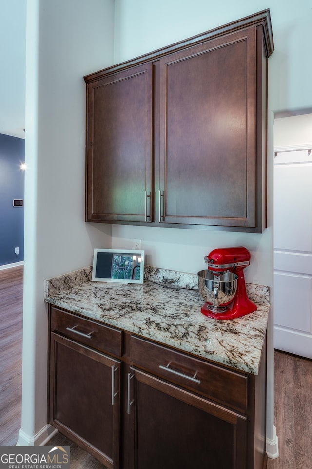 104 Johansen Way, Kingsland, GA 31548 - kitchen featuring wood finished floors, dark brown cabinetry, and light stone counters