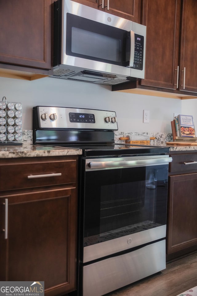 104 Johansen Way, Kingsland, GA 31548 - kitchen with stainless steel appliances, dark brown cabinets, and wood finished floors