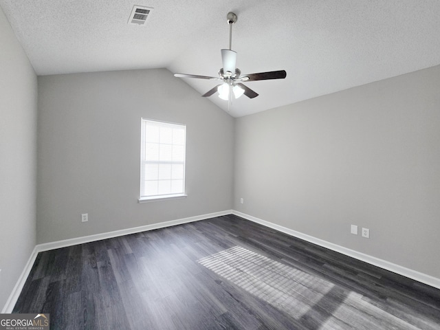3075 Lakeside Cir, Covington, GA 30016 - empty room featuring a ceiling fan, dark wood finished floors, a textured ceiling, vaulted ceiling, and baseboards