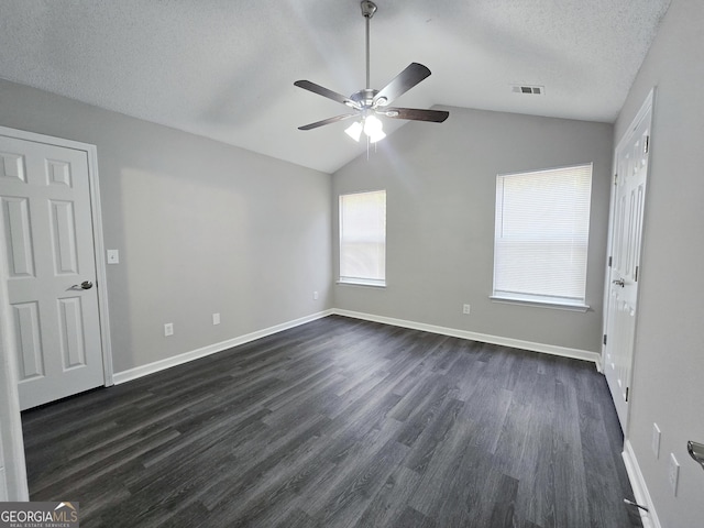 3075 Lakeside Cir, Covington, GA 30016 - unfurnished bedroom with lofted ceiling, dark wood-style flooring, baseboards, a textured ceiling, and ceiling fan