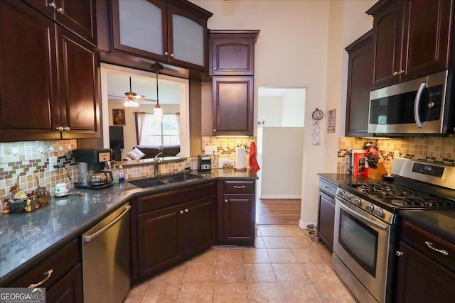 236 Hiram Sudie Rd, Dallas, GA 30157 - kitchen featuring stainless steel appliances, a sink, decorative backsplash, dark stone counters, and baseboards