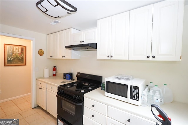 236 Hiram Sudie Rd, Dallas, GA 30157 - kitchen with gas stove, white microwave, under cabinet range hood, and white cabinets