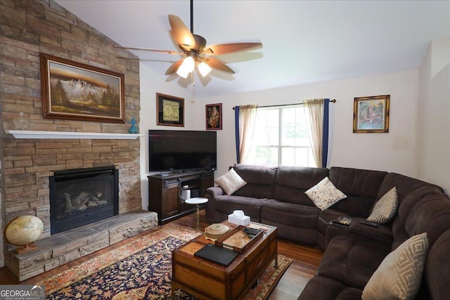236 Hiram Sudie Rd, Dallas, GA 30157 - living room with a ceiling fan, wood finished floors, lofted ceiling, and a stone fireplace