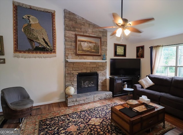 236 Hiram Sudie Rd, Dallas, GA 30157 - living area featuring wood finished floors, a ceiling fan, a stone fireplace, and vaulted ceiling