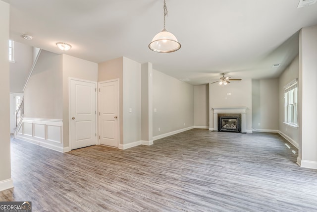 31 Blarneystone Way, Adairsville, GA 30103 - unfurnished living room with wood finished floors, a ceiling fan, a fireplace with flush hearth, and baseboards