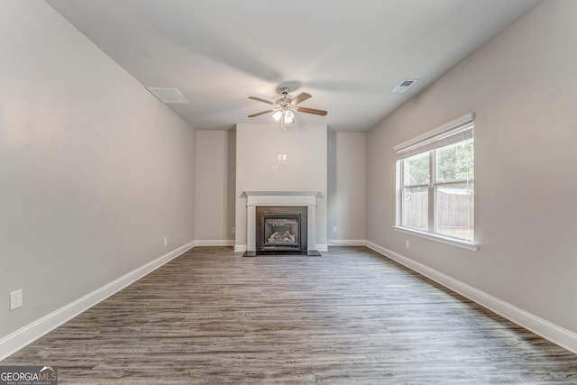 31 Blarneystone Way, Adairsville, GA 30103 - unfurnished living room with a ceiling fan, a fireplace with flush hearth, wood finished floors, and baseboards