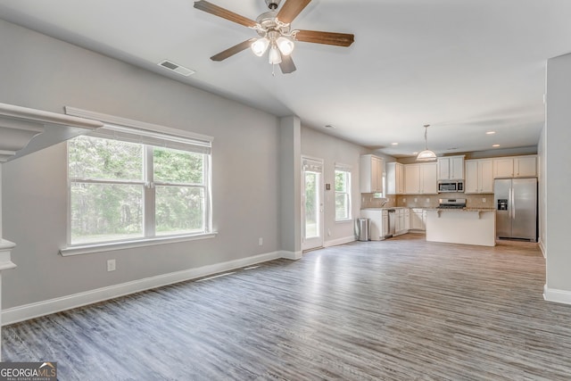 31 Blarneystone Way, Adairsville, GA 30103 - unfurnished living room with baseboards, ceiling fan, light wood finished floors, recessed lighting, and a sink