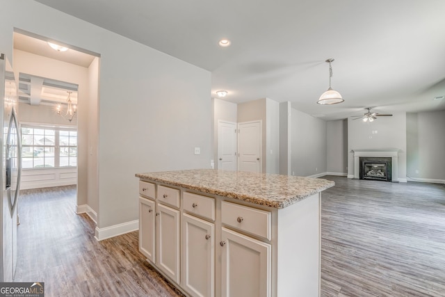31 Blarneystone Way, Adairsville, GA 30103 - kitchen featuring a ceiling fan, light wood-style floors, a glass covered fireplace, baseboards, and recessed lighting