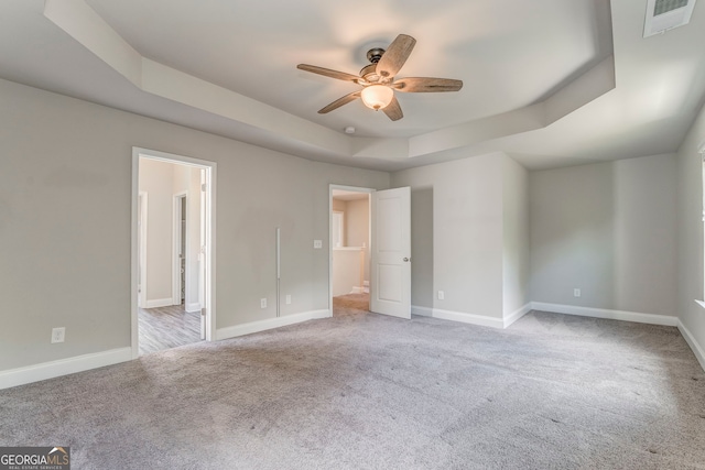 31 Blarneystone Way, Adairsville, GA 30103 - unfurnished bedroom featuring a tray ceiling, light carpet, baseboards, ceiling fan, and connected bathroom