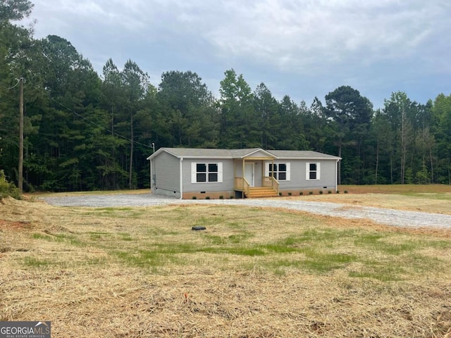 429 Avant Rd, Eatonton, GA 31024 - single story home featuring crawl space, a wooded view, and a front lawn