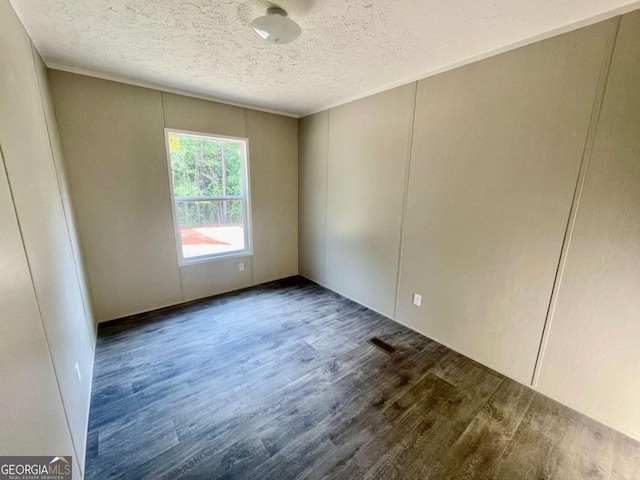429 Avant Rd, Eatonton, GA 31024 - spare room featuring wood finished floors and a textured ceiling