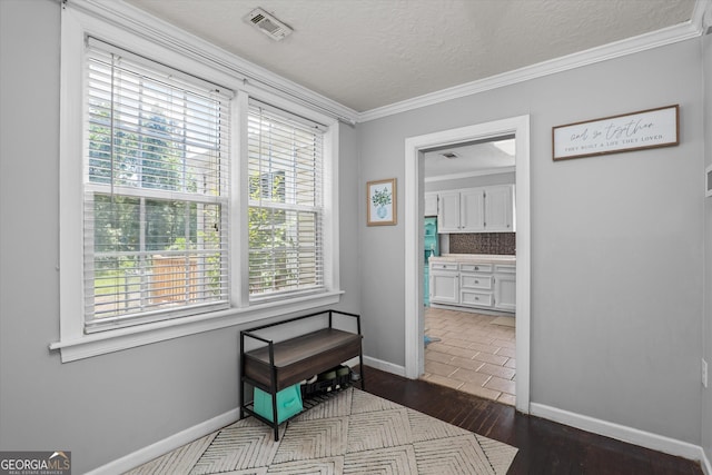 1055 Wrens Hwy, Thomson, GA 30824 - hall featuring plenty of natural light, a textured ceiling, crown molding, baseboards, and dark wood finished floors