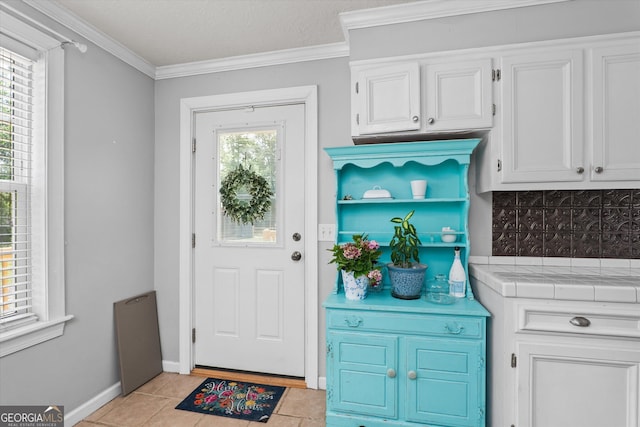1055 Wrens Hwy, Thomson, GA 30824 - entrance foyer featuring ornamental molding, light tile patterned floors, and baseboards