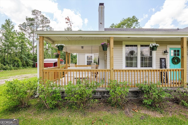 1055 Wrens Hwy, Thomson, GA 30824 - view of front of home with covered porch, a chimney, and a carport