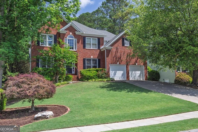 320 Ironhill Trce, Woodstock, GA 30189 - colonial inspired home with driveway, brick siding, a front yard, and an attached garage