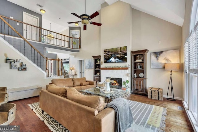 320 Ironhill Trce, Woodstock, GA 30189 - living area featuring ceiling fan, high vaulted ceiling, wood finished floors, stairway, and a fireplace