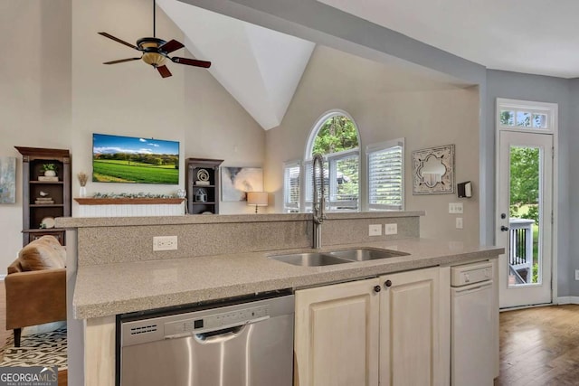 320 Ironhill Trce, Woodstock, GA 30189 - kitchen featuring stainless steel dishwasher, open floor plan, healthy amount of natural light, wood finished floors, and high vaulted ceiling