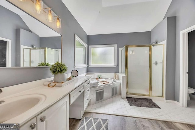 320 Ironhill Trce, Woodstock, GA 30189 - full bathroom featuring a stall shower, wood finished floors, vanity, a bath, and toilet