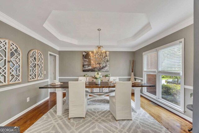 320 Ironhill Trce, Woodstock, GA 30189 - dining space with crown molding, a raised ceiling, a chandelier, and light wood-type flooring