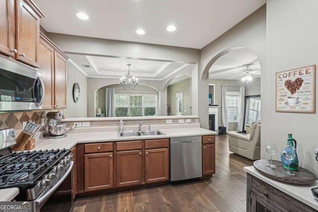 2910 Cross Creek Dr, Cumming, GA 30040 - kitchen featuring appliances with stainless steel finishes, a sink, arched walkways, dark wood-style floors, and recessed lighting