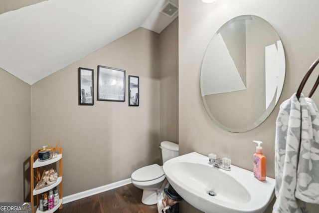 2910 Cross Creek Dr, Cumming, GA 30040 - bathroom featuring vaulted ceiling, toilet, wood finished floors, a sink, and baseboards