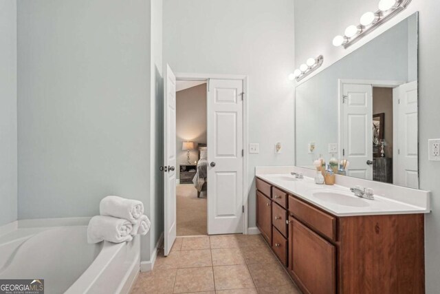 2910 Cross Creek Dr, Cumming, GA 30040 - ensuite bathroom with double vanity, a bath, tile patterned flooring, and baseboards