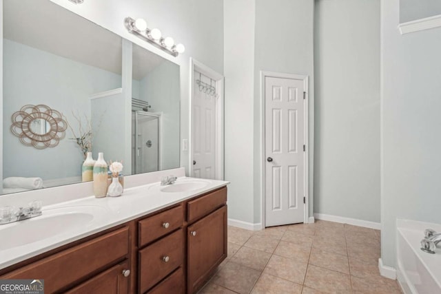 2910 Cross Creek Dr, Cumming, GA 30040 - full bathroom featuring a shower stall, double vanity, a bath, tile patterned floors, and baseboards