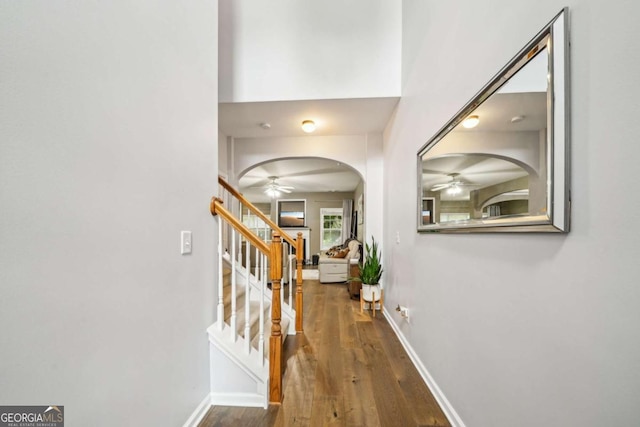 2910 Cross Creek Dr, Cumming, GA 30040 - foyer entrance with a ceiling fan, wood finished floors, arched walkways, and stairway