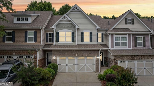 2910 Cross Creek Dr, Cumming, GA 30040 - view of property with a garage, concrete driveway, a shingled roof, and brick siding