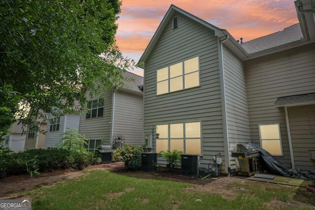 2910 Cross Creek Dr, Cumming, GA 30040 - back of property at dusk featuring central AC